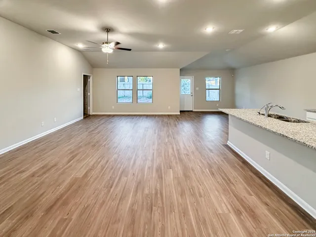 a view of a room with window and wooden floor