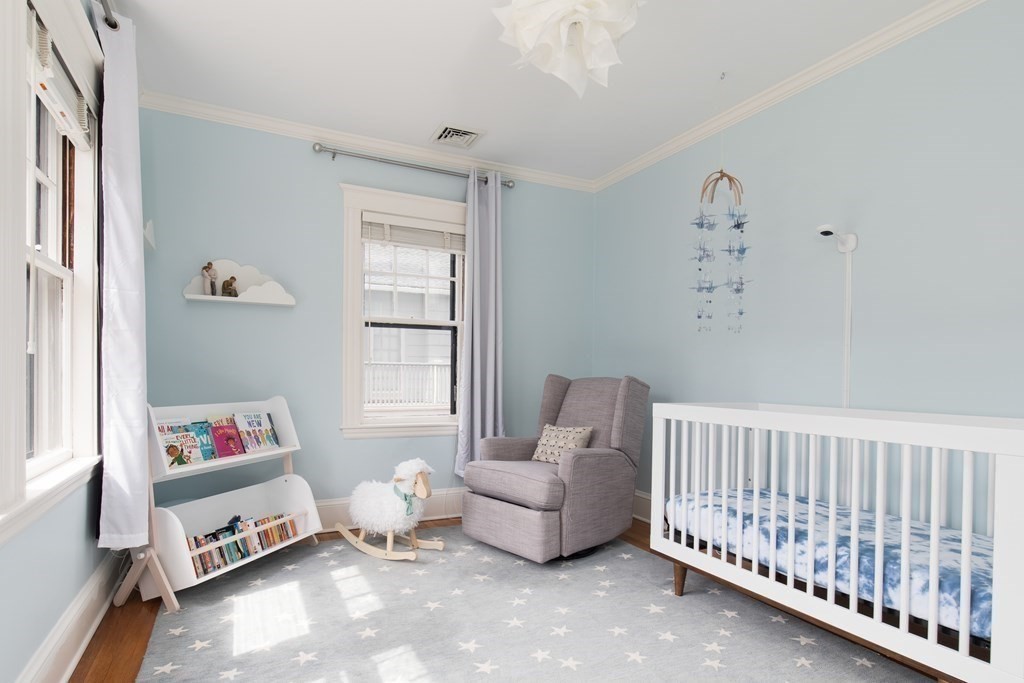 6-8 Longfellow Road Cambridge, MA 02138 - Photo 19 of 40 a living room with furniture and a baby crib