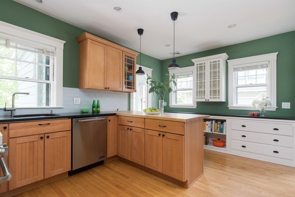 6-8 Longfellow Road Cambridge, MA 02138 - Photo 2 of 40 a kitchen with a wooden floor and white cabinets