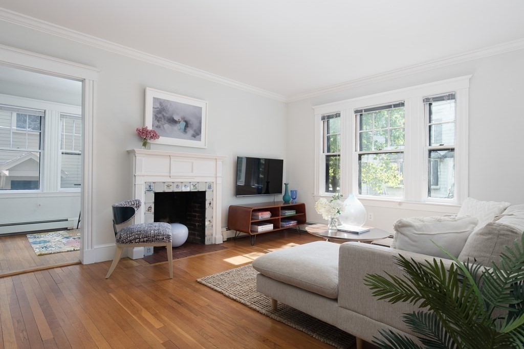 6-8 Longfellow Road Cambridge, MA 02138 - Photo 22 of 40 a living room with furniture a flat screen tv and a fireplace