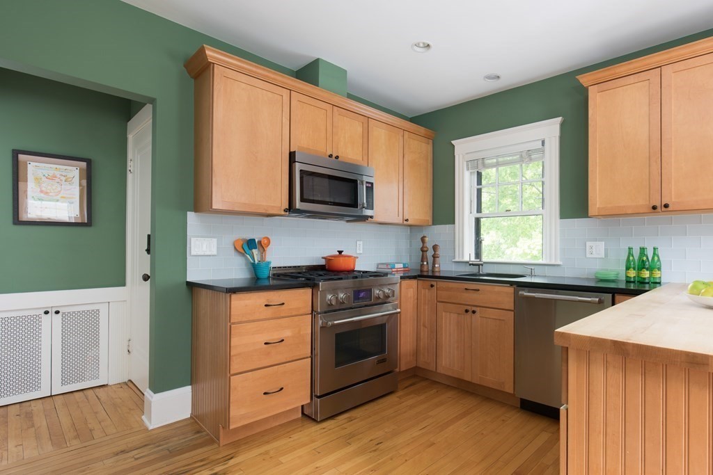 6-8 Longfellow Road Cambridge, MA 02138 - Photo 4 of 40 a kitchen with cabinets stainless steel appliances a sink and a window