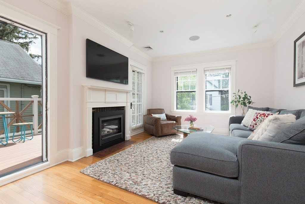 6-8 Longfellow Road Cambridge, MA 02138 - Photo 8 of 40 a living room with furniture a flat screen tv and a fireplace