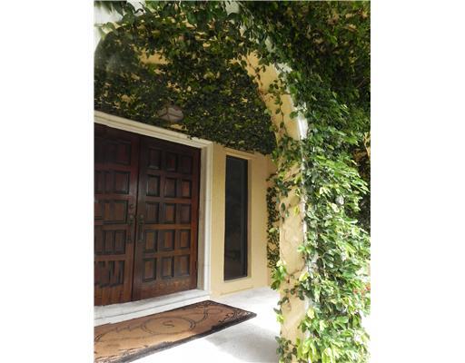 3 Middle Road Stuart, FL 34996 - Photo 3 of 25 a couple of potted plants in front of door