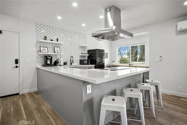 a kitchen with stainless steel appliances a sink and a refrigerator