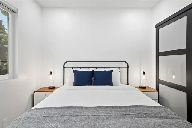 a bedroom with furniture and a flat screen tv