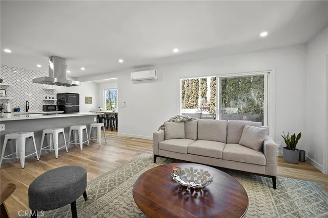 a kitchen with a sink dishwasher and a stove with wooden floor