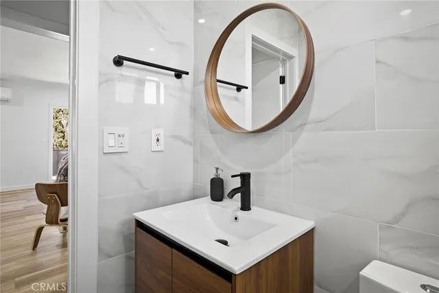 a bedroom with a bed and a mirror