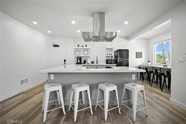 a kitchen with cabinets table and chairs