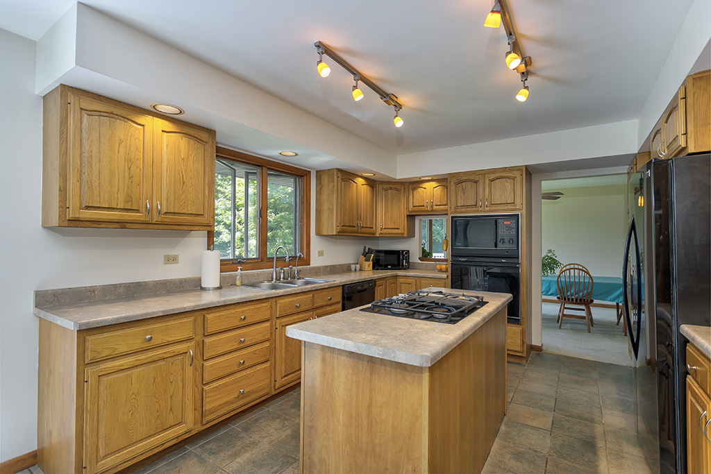 19003 Righeimer Road Harvard, IL 60033 - Photo 14 of 42 a kitchen with a stove a sink a refrigerator and dining table