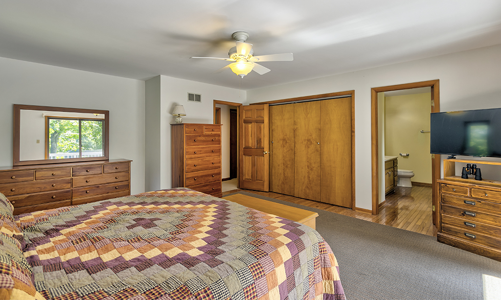 19003 Righeimer Road Harvard, IL 60033 - Photo 22 of 42 a bedroom with a bed and a chandelier