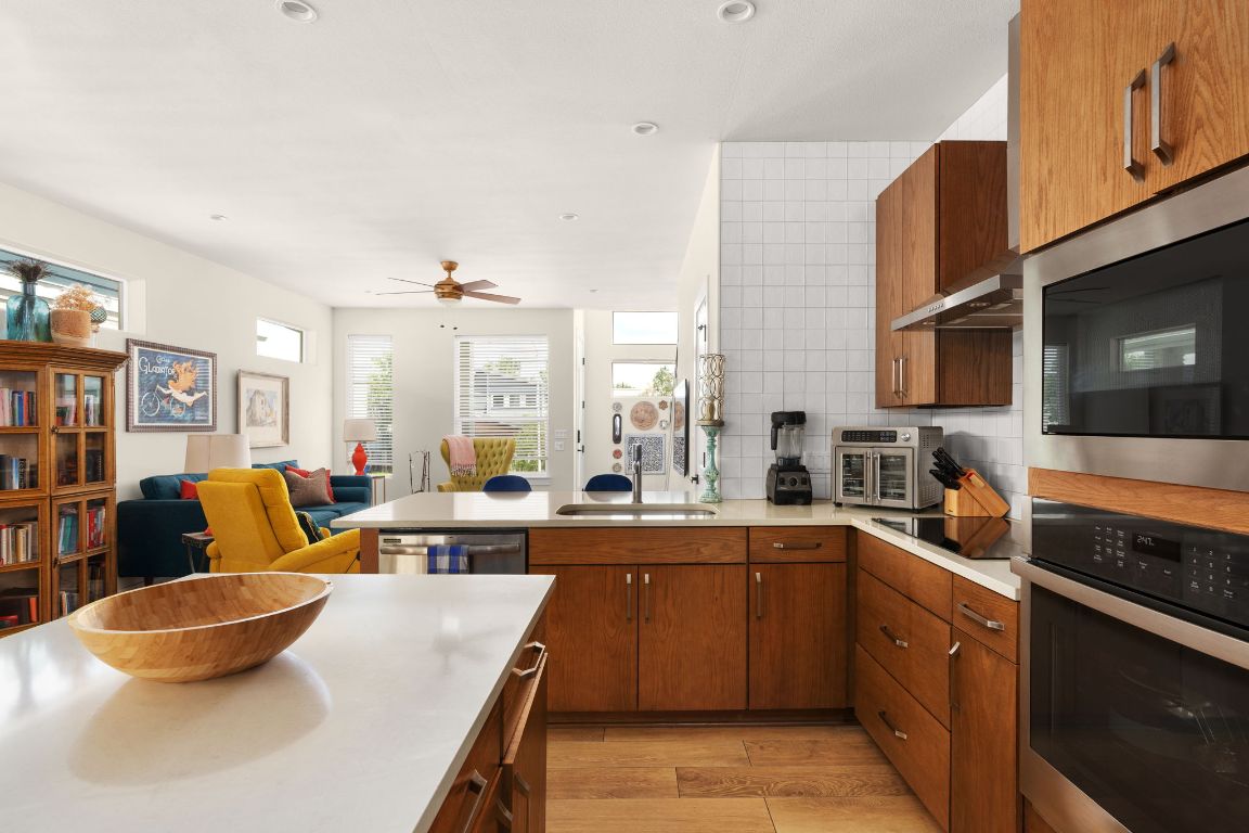 a large white kitchen with a large window