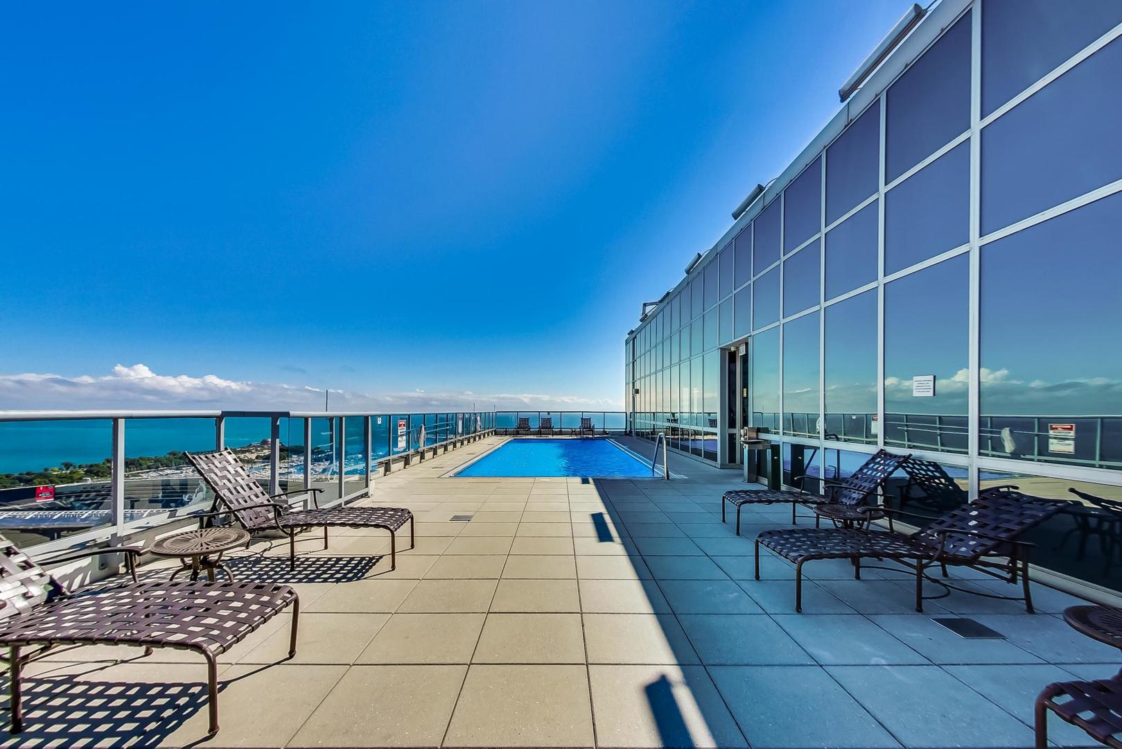 1629 South Prairie Avenue, Unit 1806 Chicago, IL 60616 - Photo 24 of 27 a balcony with chairs and outdoor seating
