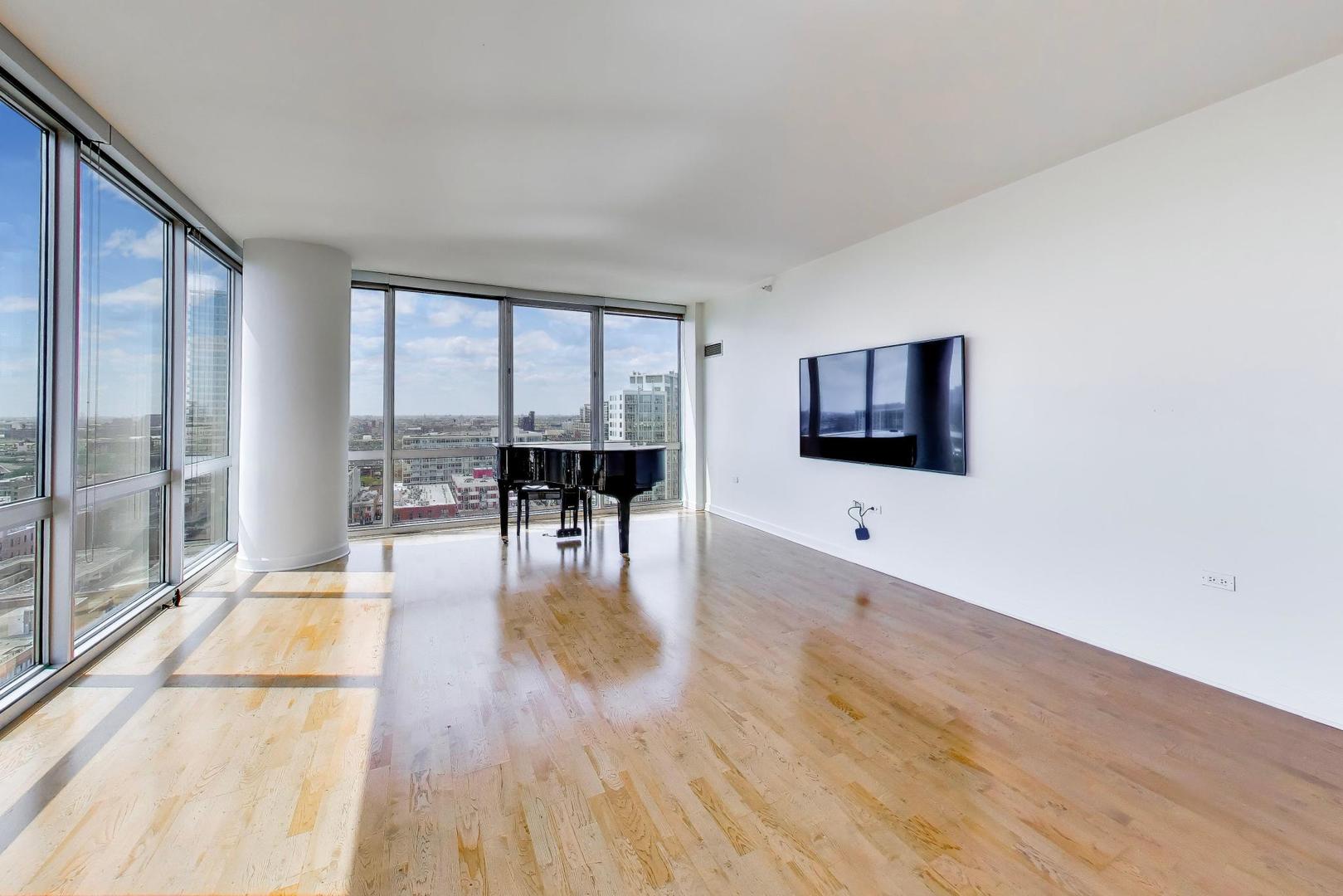 1629 South Prairie Avenue, Unit 1806 Chicago, IL 60616 - Photo 3 of 27 a living room with furniture wooden floor and a flat screen tv