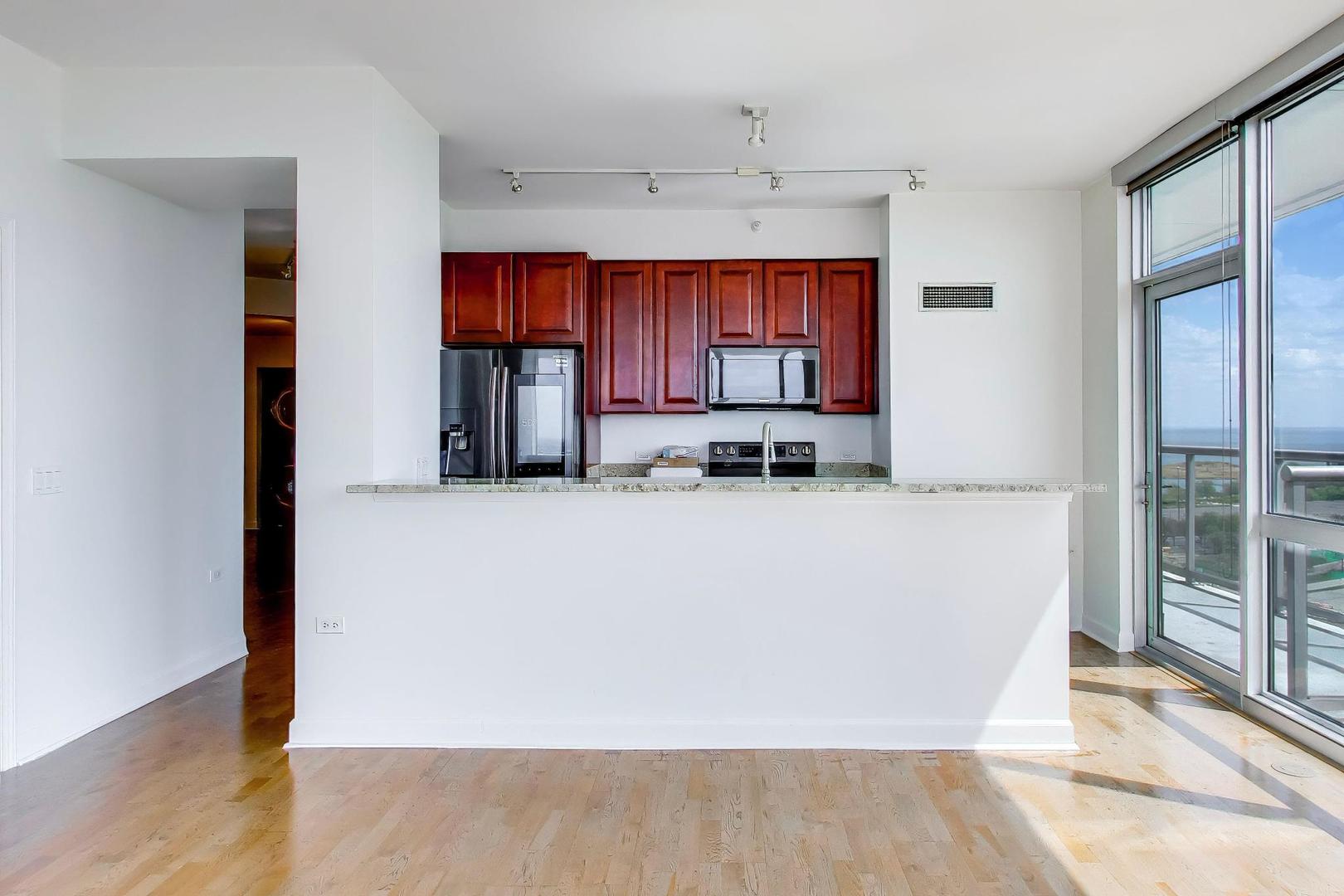 1629 South Prairie Avenue, Unit 1806 Chicago, IL 60616 - Photo 5 of 27 a room with wooden cabinets and window