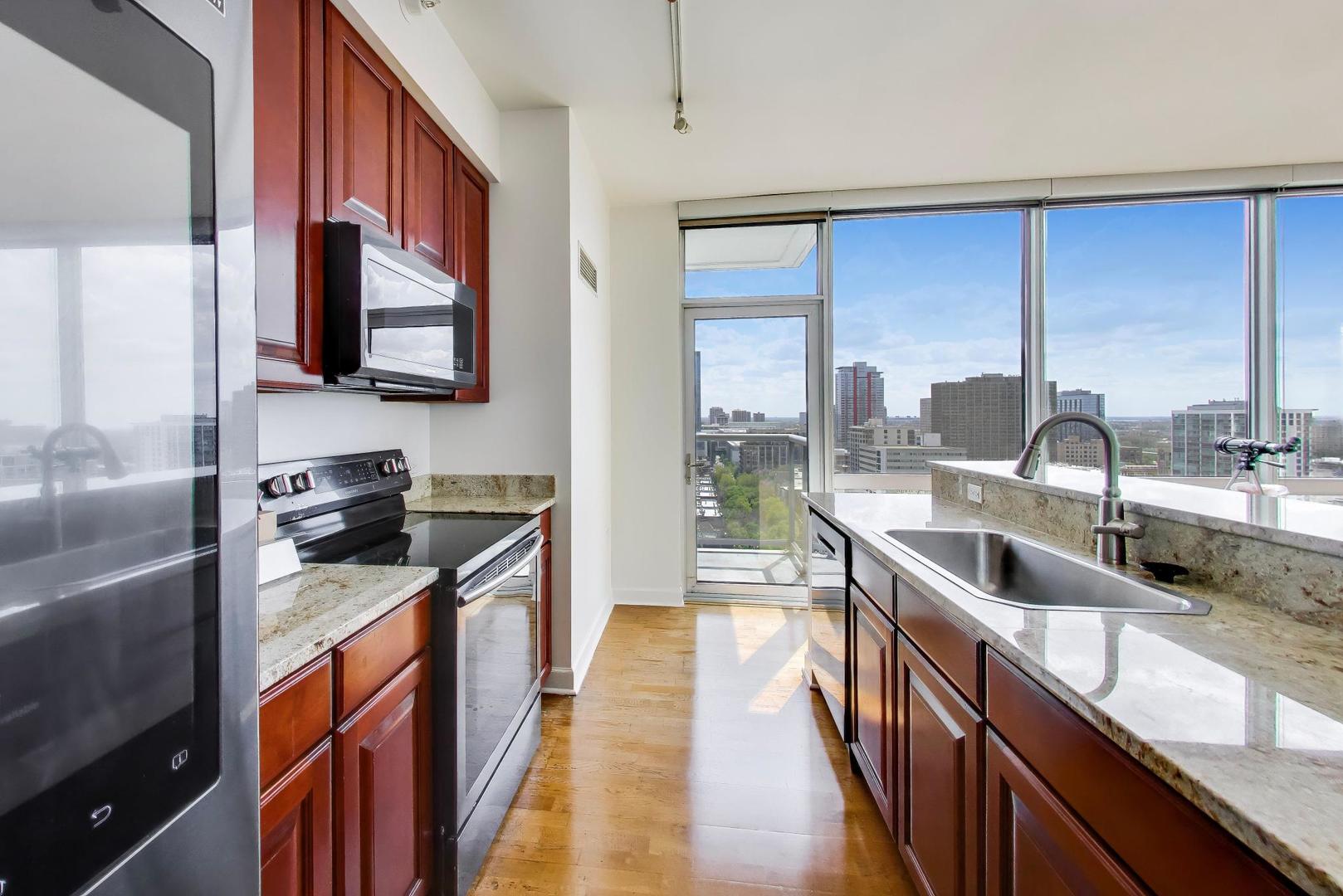 1629 South Prairie Avenue, Unit 1806 Chicago, IL 60616 - Photo 6 of 27 a kitchen with stainless steel appliances granite countertop a sink and a stove