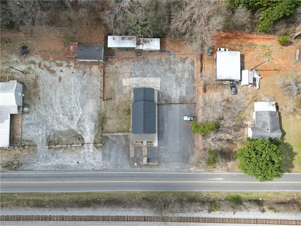 a white building with a tree in front of it