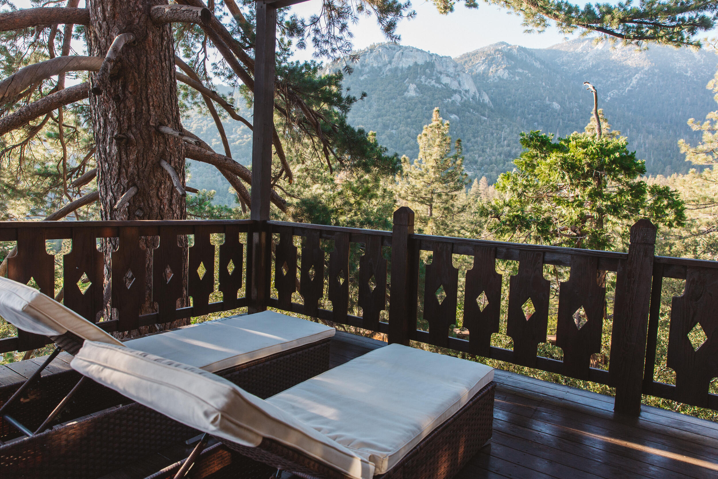55540 Howland Road Idyllwild, CA 92549 - Photo 38 of 76 a view of a deck with wooden floor and outdoor seating