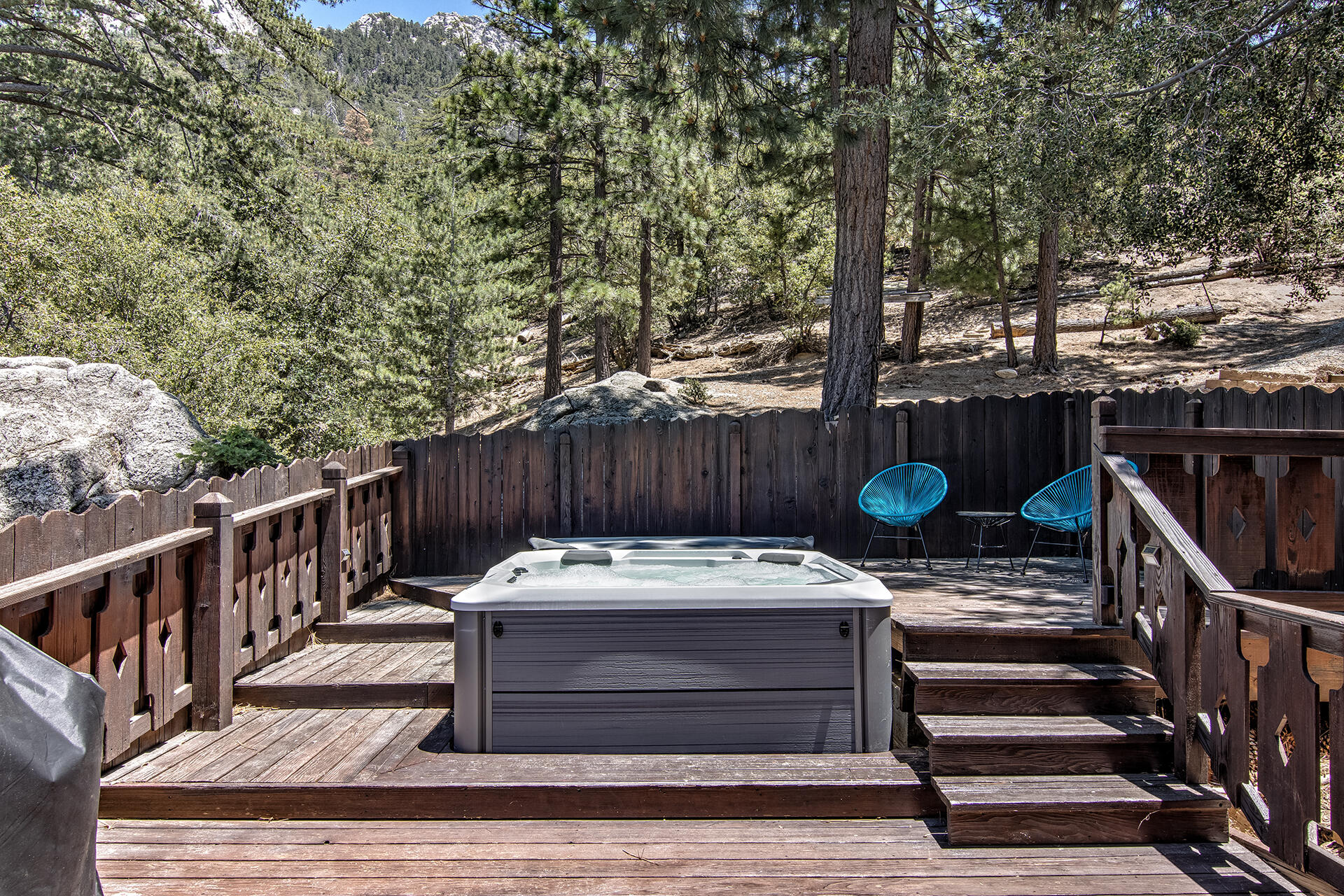 55540 Howland Road Idyllwild, CA 92549 - Photo 40 of 76 a view of a wooden deck with chairs and a table