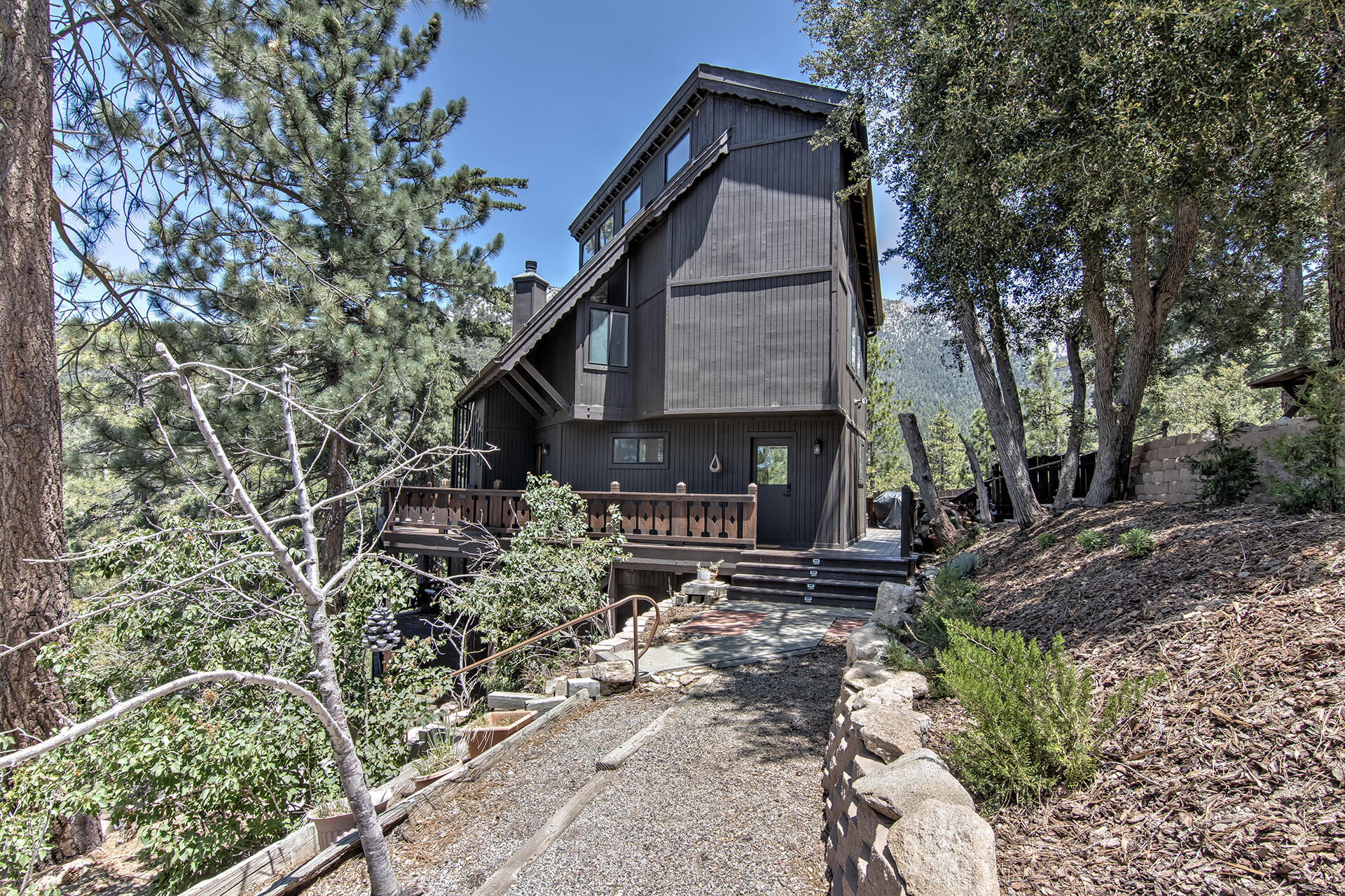 55540 Howland Road Idyllwild, CA 92549 - Photo 63 of 76 a view of a house with a yard and sitting area