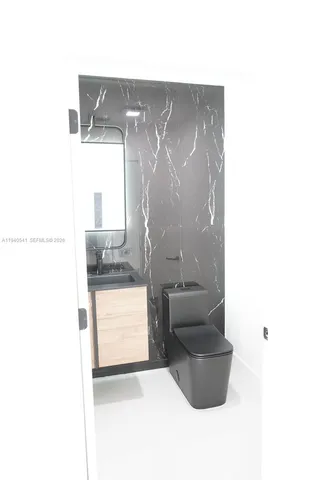 a living room with a couch and a dining table