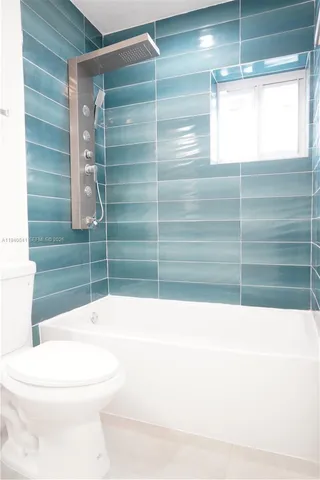 a bathroom with a toilet a sink and bathtub