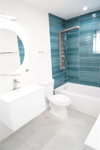 a bathroom with a sink mirror and a bathtub