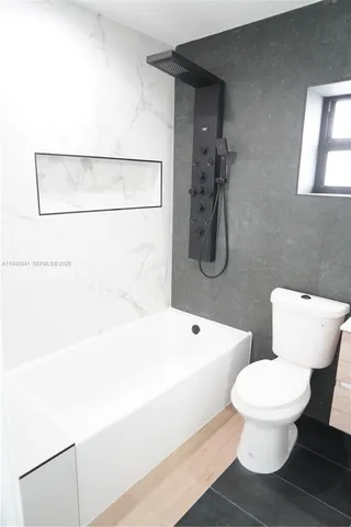 a bathroom with a toilet sink and a mirror