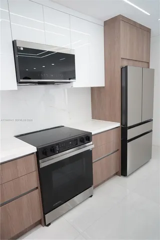 a kitchen with stainless steel appliances a stove and a refrigerator