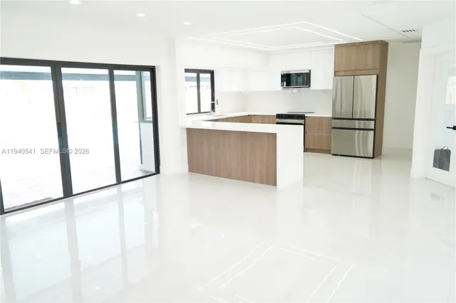 a kitchen with stainless steel appliances a refrigerator and a sink