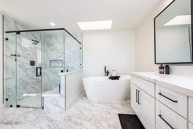 a spacious bathroom with a double vanity sink mirror and shower
