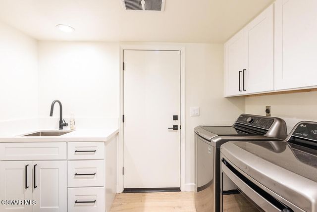 a kitchen with appliances cabinets and a sink