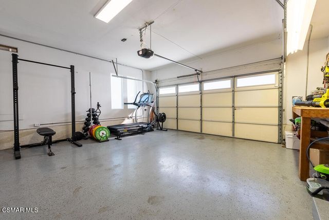 a view of a room with gym equipment and a window