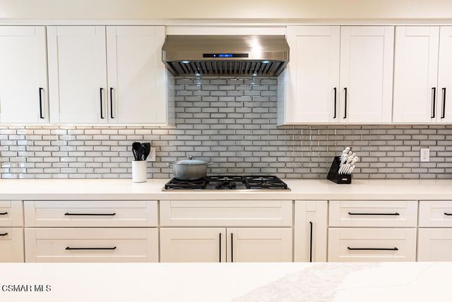 a kitchen with a sink cabinets and appliances