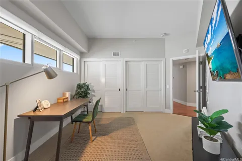a living room with furniture and potted plant