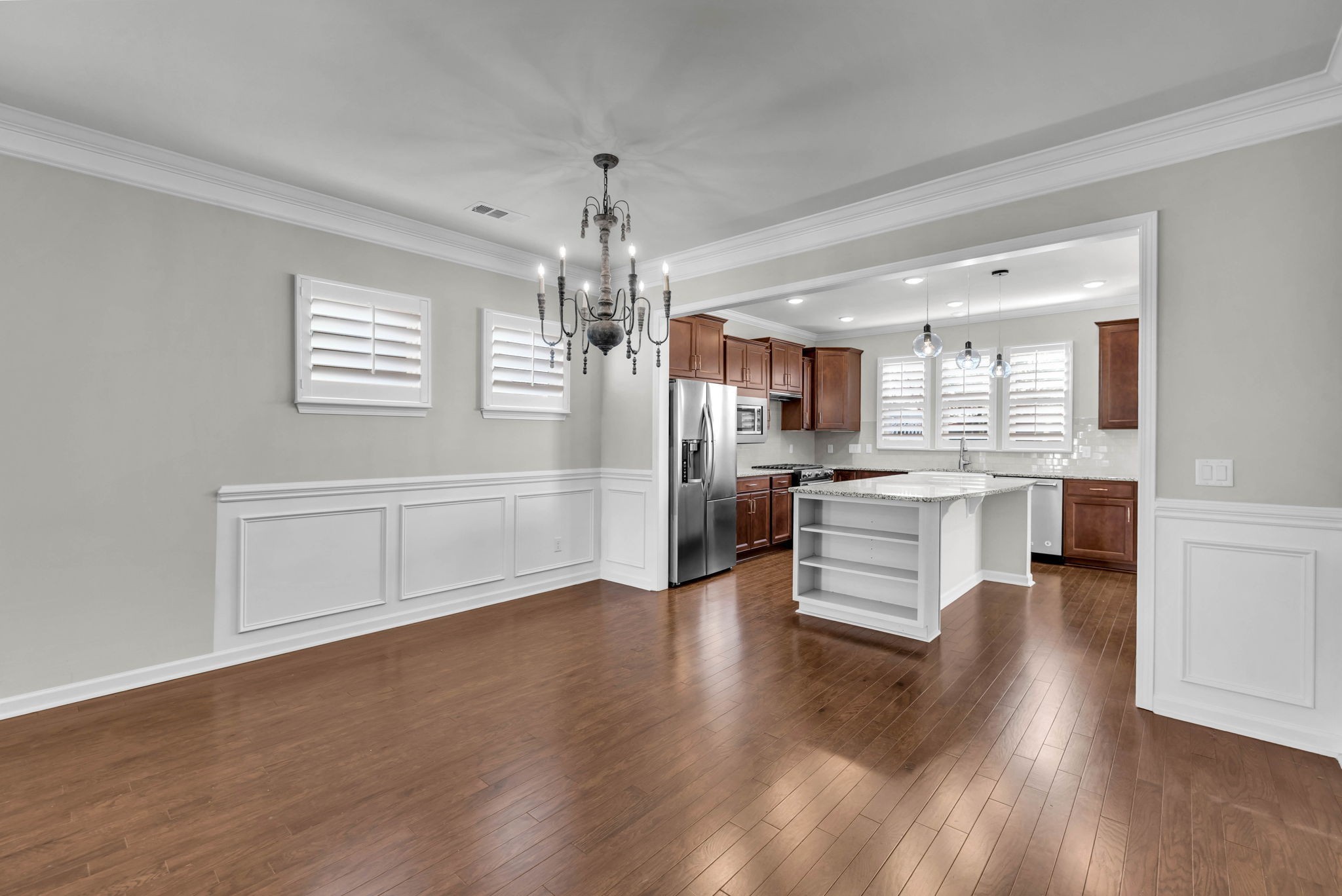 843 Clay Place Spring Hill, TN 37174 - Photo 12 of 56 a large open kitchen with a refrigerator a stove a sink dishwasher and white cabinets with wooden floor