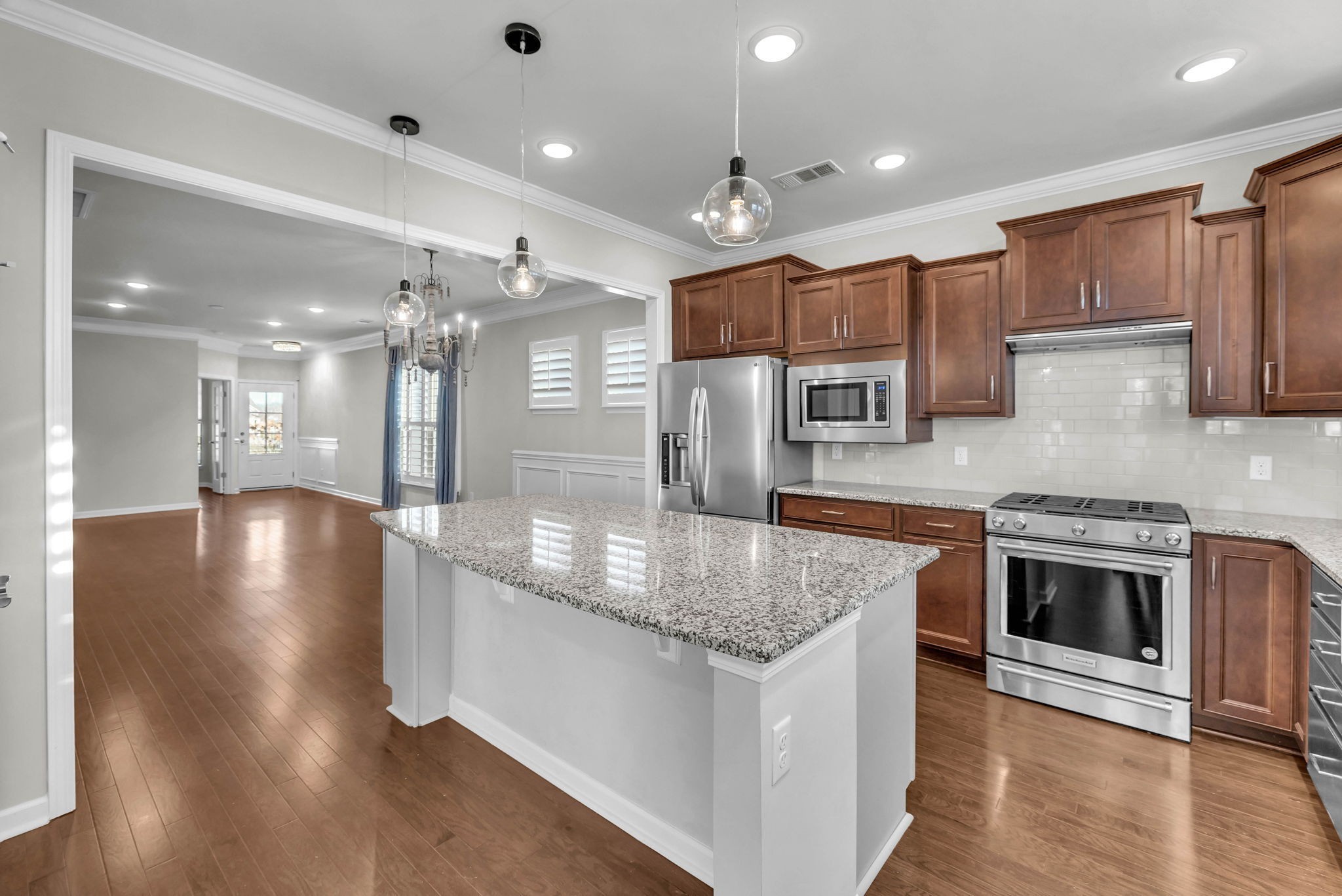 843 Clay Place Spring Hill, TN 37174 - Photo 19 of 56 a kitchen with stainless steel appliances granite countertop a sink a stove and a wooden floors