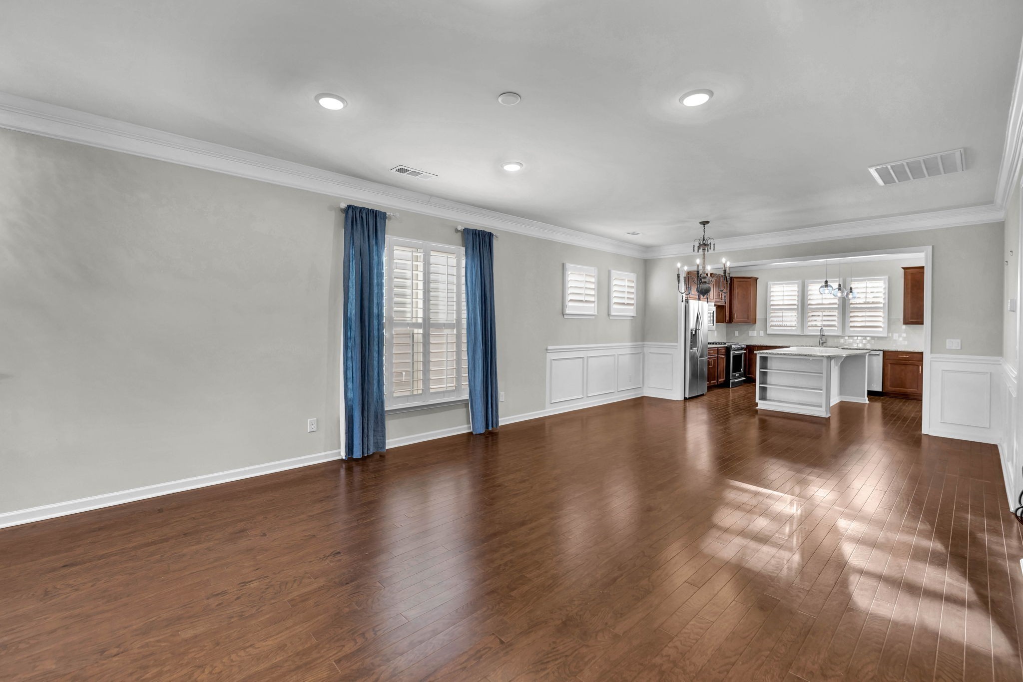 843 Clay Place Spring Hill, TN 37174 - Photo 24 of 56 a view of empty room with wooden floor and a kitchen