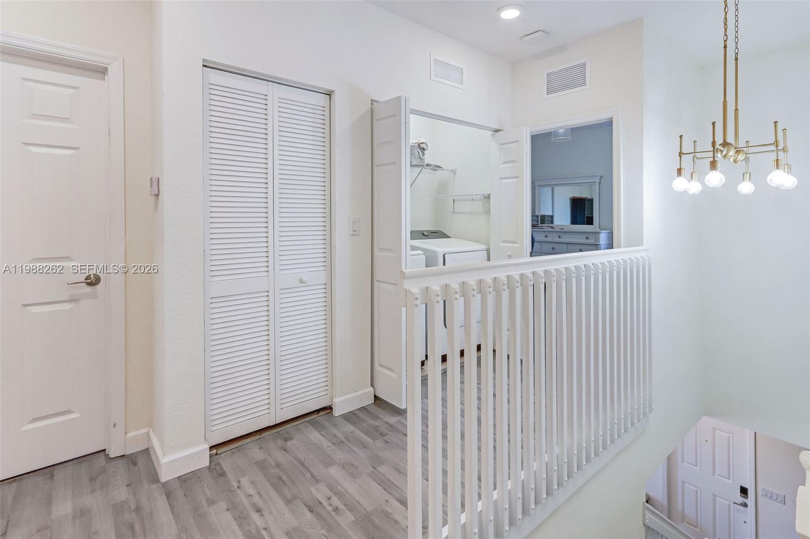 3375 West 100th Terrace Hialeah, FL 33018 - Photo 11 of 27 a view of a hallway with wooden floor