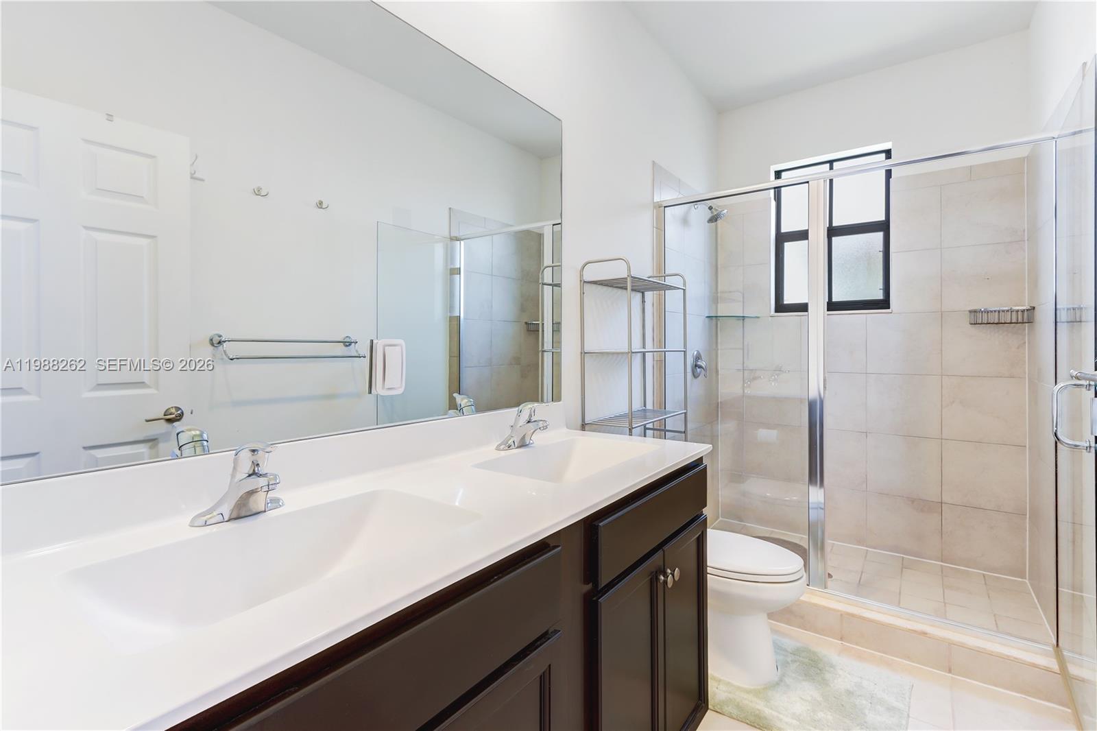 3375 West 100th Terrace Hialeah, FL 33018 - Photo 14 of 27 a bathroom with a sink and a mirror