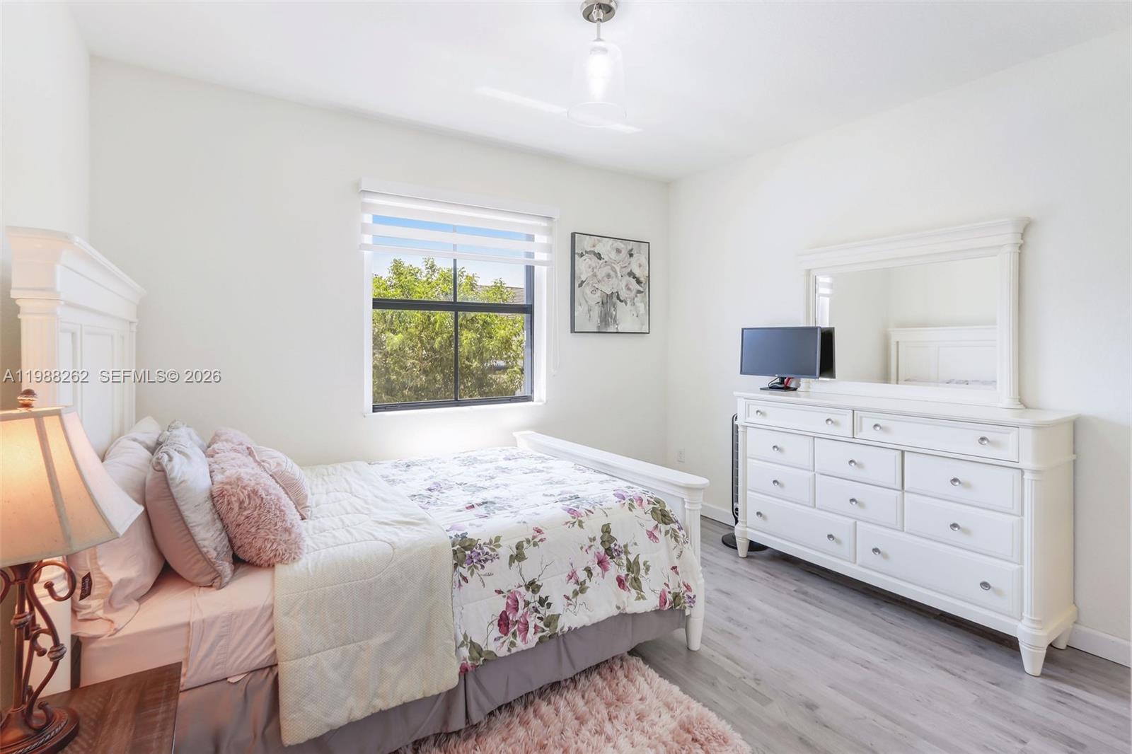 3375 West 100th Terrace Hialeah, FL 33018 - Photo 15 of 27 a bedroom with a bed and a dresser