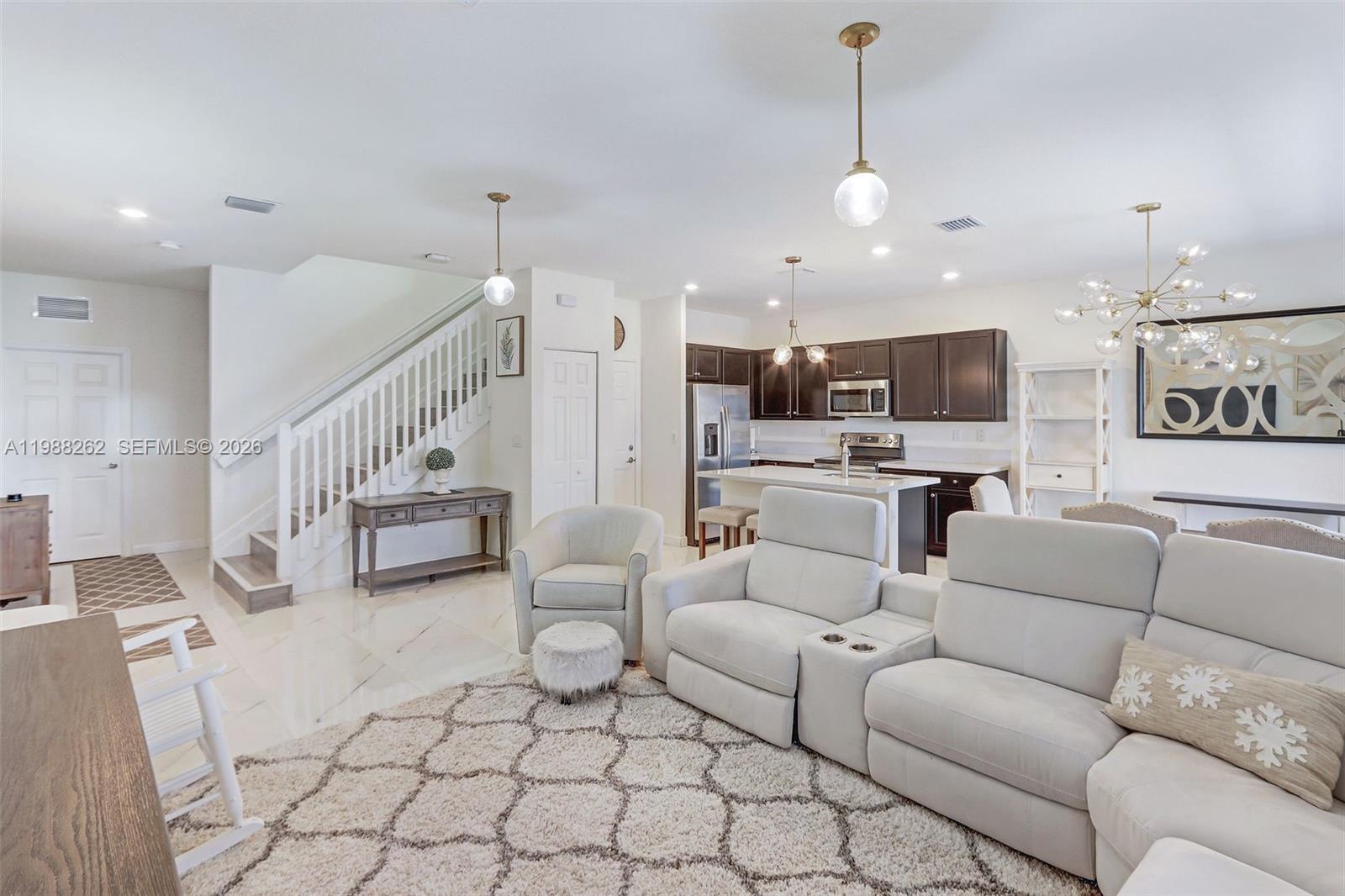 3375 West 100th Terrace Hialeah, FL 33018 - Photo 4 of 27 a living room with furniture and kitchen view