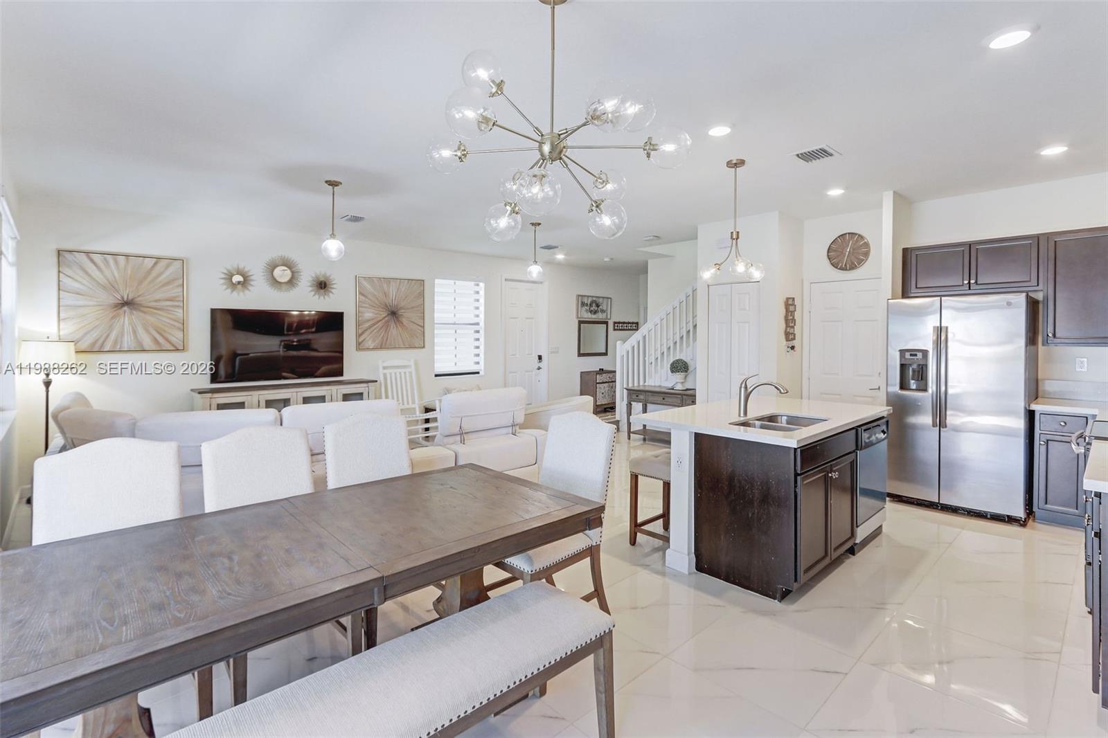 3375 West 100th Terrace Hialeah, FL 33018 - Photo 7 of 27 a living room with stainless steel appliances furniture and a flat screen tv