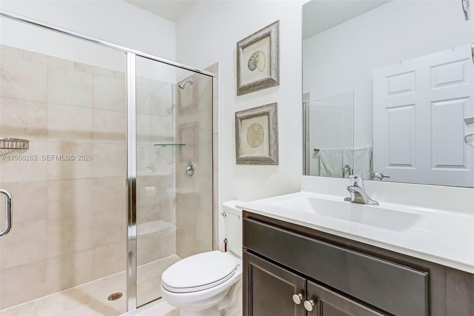 3375 West 100th Terrace Hialeah, FL 33018 - Photo 10 of 27 a bathroom with a sink toilet and shower