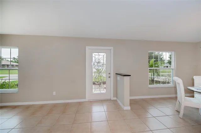 a view of a hallway with wooden floor and furniture