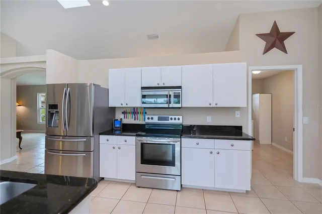 a living room with furniture and kitchen view