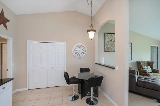 a living room with furniture a flat screen tv and floor to ceiling window