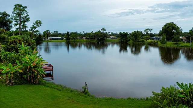 a view of a lake with houses in background