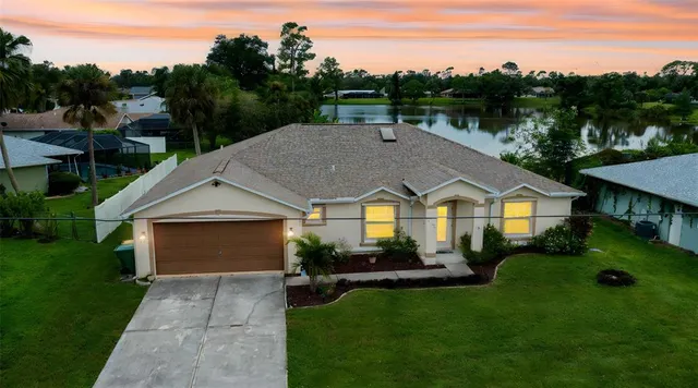 a front view of a house with a garden and yard