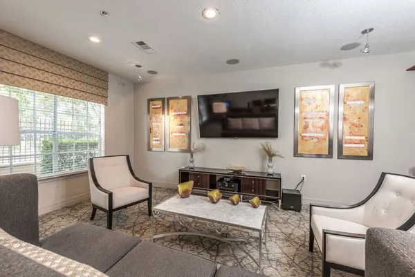 a living room with furniture a flat screen tv and large window
