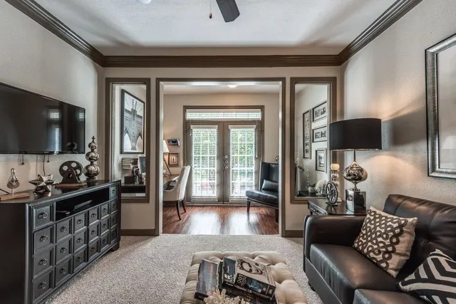 a living room with furniture and wooden floor